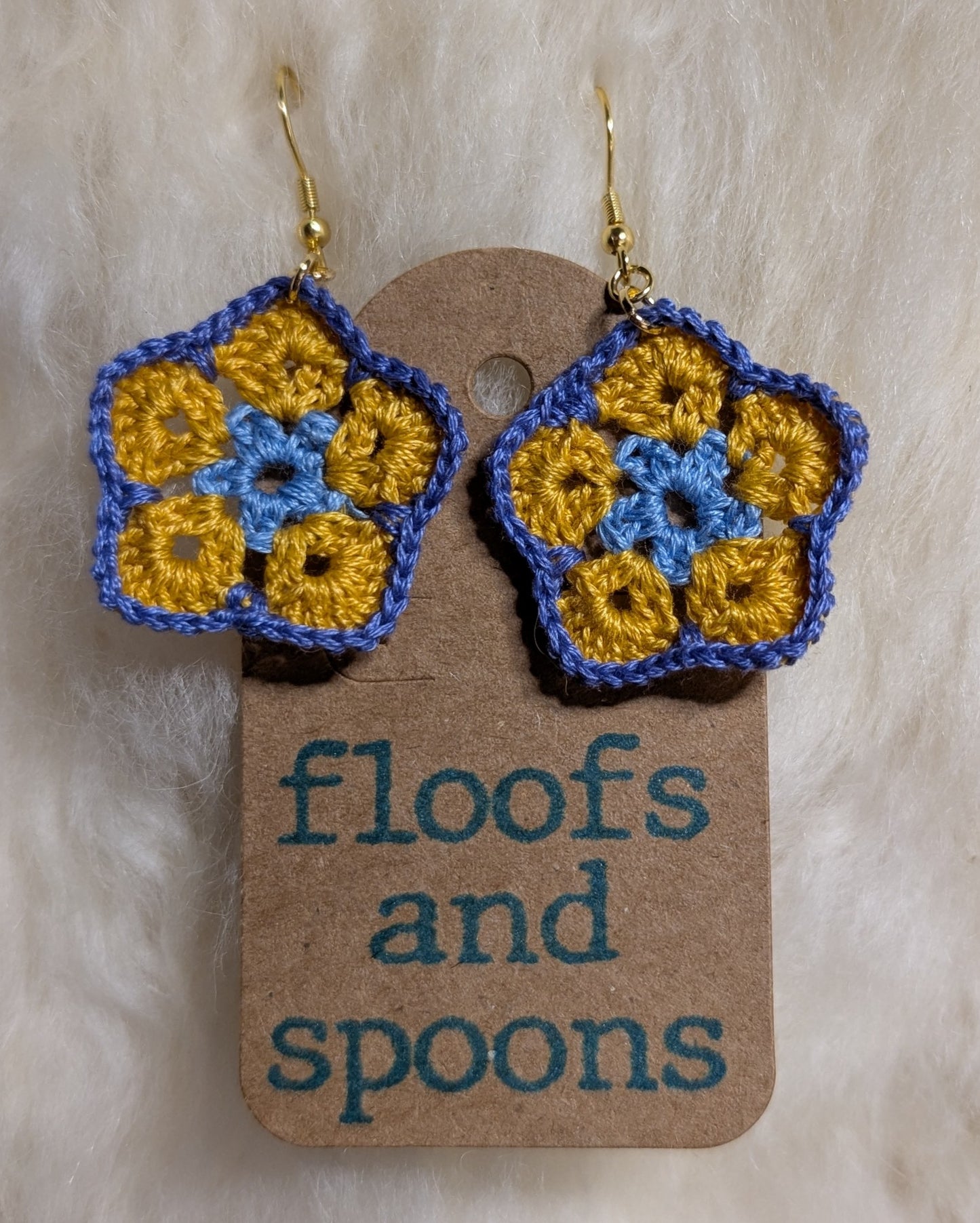 Light blue, yellow, light purple/blue African violet (s)