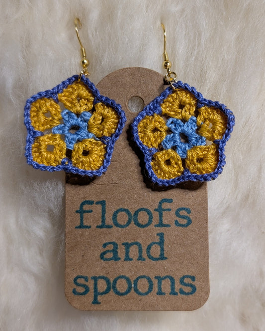 Light blue, yellow, light purple/blue African violet (s)