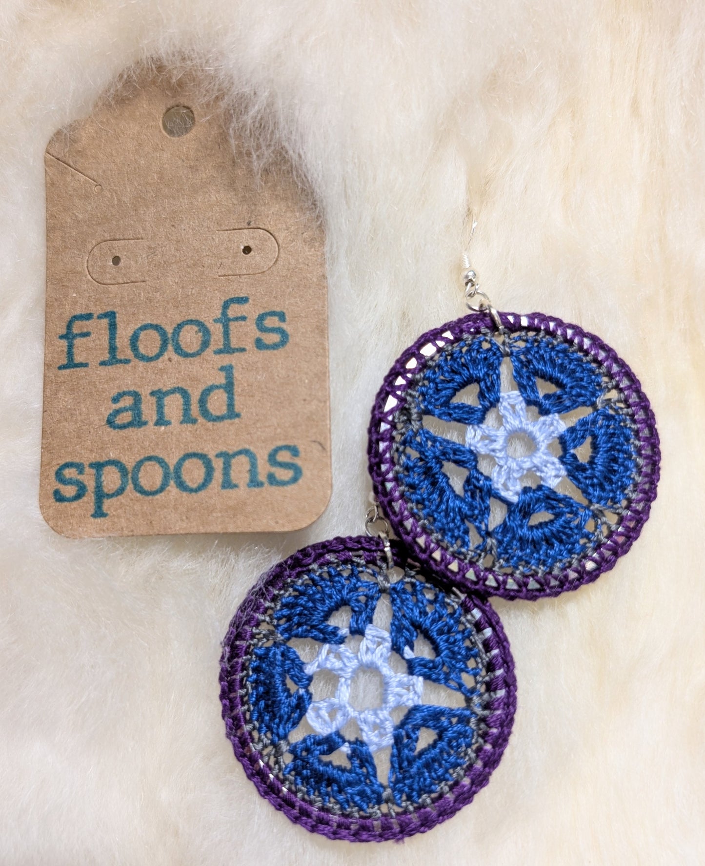 Light blue, navy blue, purple African violets in hoop (m)